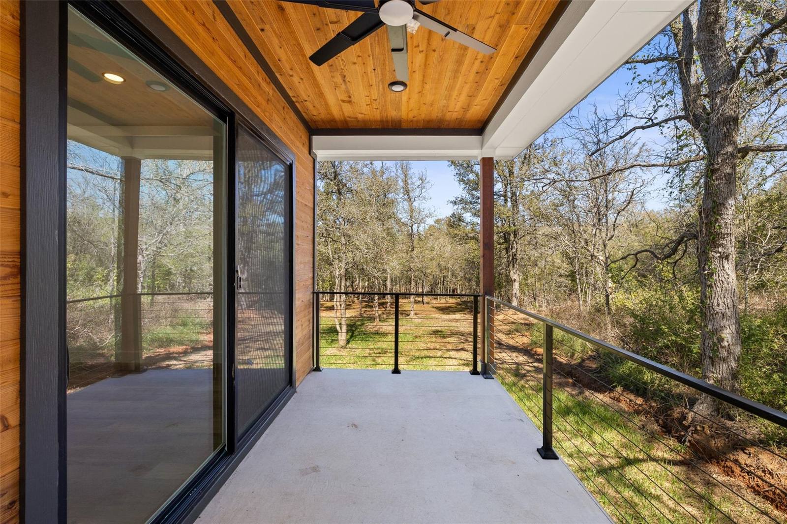 Aerial view of modern farmhouse with large deck